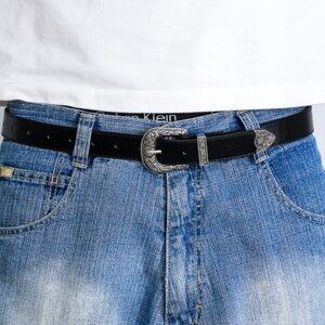 y2k silver buckle black tooled leather belt — western swirl wave style